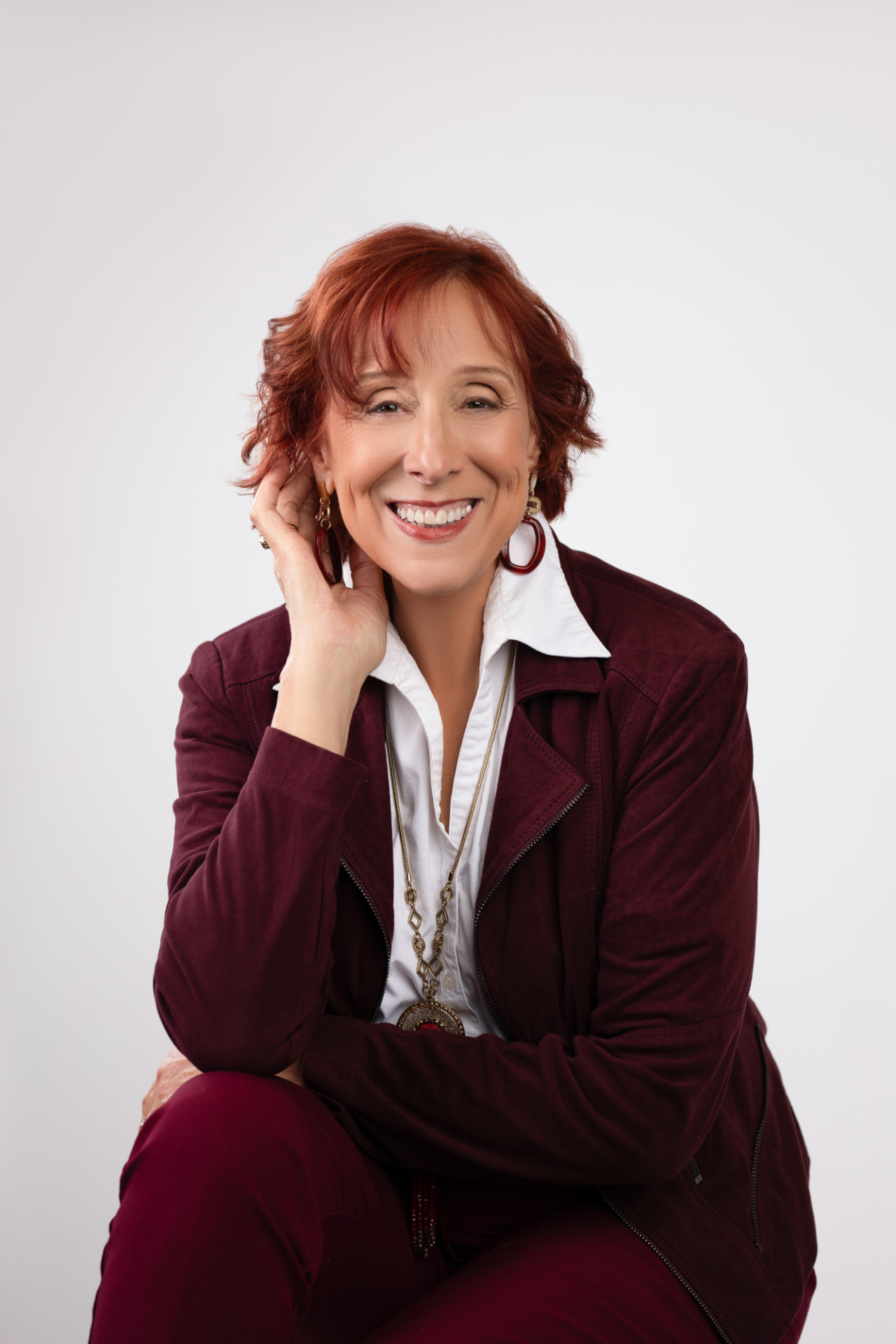Chantal Cleroux, founder of CC MoneyWise+, smiling in a burgundy blazer